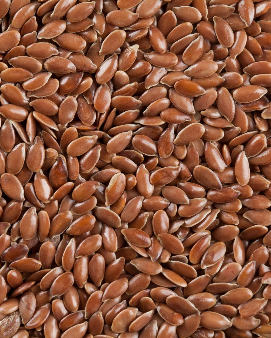 A close-up image of brown flaxseeds.